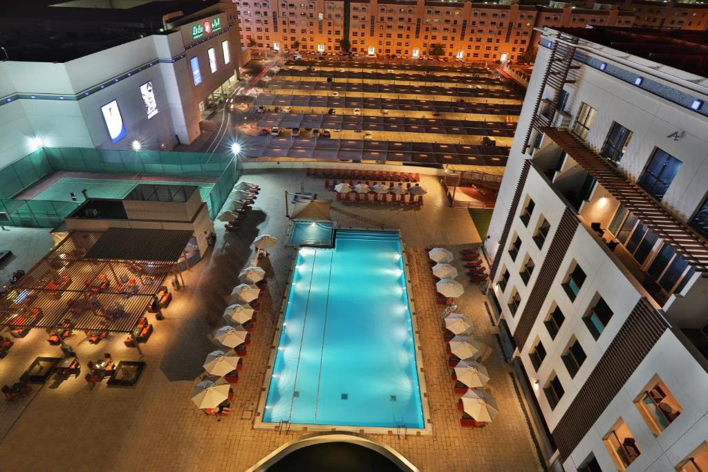 an overhead view of a swimming pool in a building at Four Points by Sheraton Al Ain in Al Ain