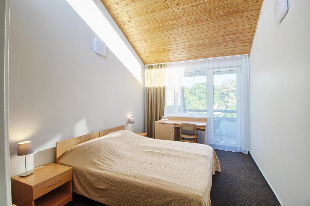 Ένα ή περισσότερα κρεβάτια σε δωμάτιο στο Vila Kastytis