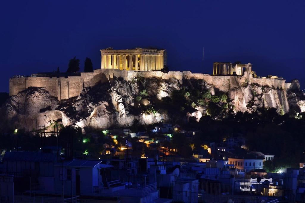 a view of the acropolis of athens at night at kolonaki Penthouse panoramic Acropolis view in Athens