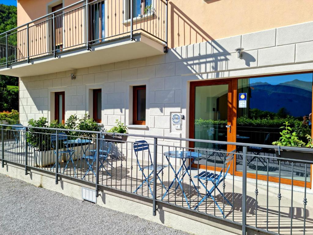 a balcony with chairs and tables in front of a building at B&B I LAKE IT BELLAGIO in Bellagio
