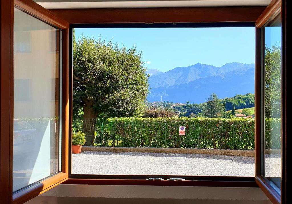 an open window with a view of a garden at B&B I LAKE IT BELLAGIO in Bellagio