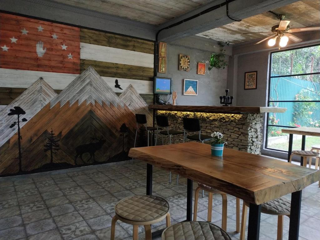 a dining room with a table and a fireplace at Время Че in Sukhum