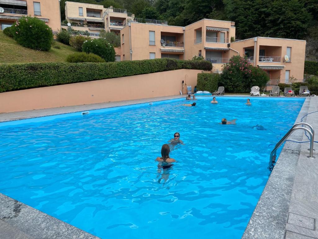 a group of people swimming in a swimming pool at Casa Bella Vista- Punta Gaeta San Siro CO in San Siro
