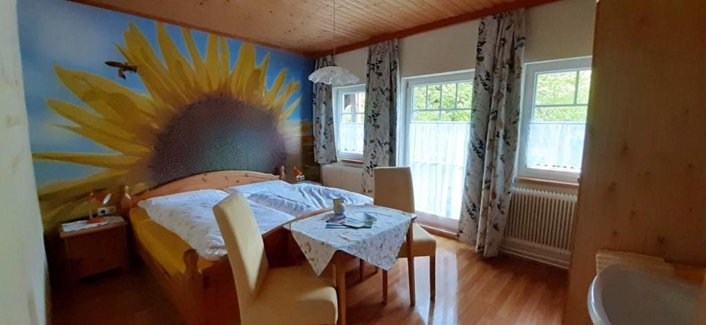 a bedroom with a sunflower painting on the wall at 5 bedrooms house with furnished garden and wifi at Pruggern 4 km away from the slopes in Pruggern