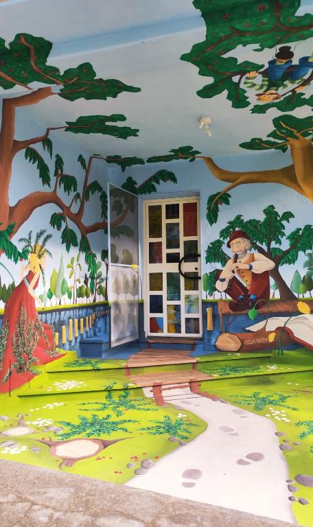 a mural of a room with a tree at B&B Arte e Rosmarino al Paese delle Fiabe in SantʼAngelo