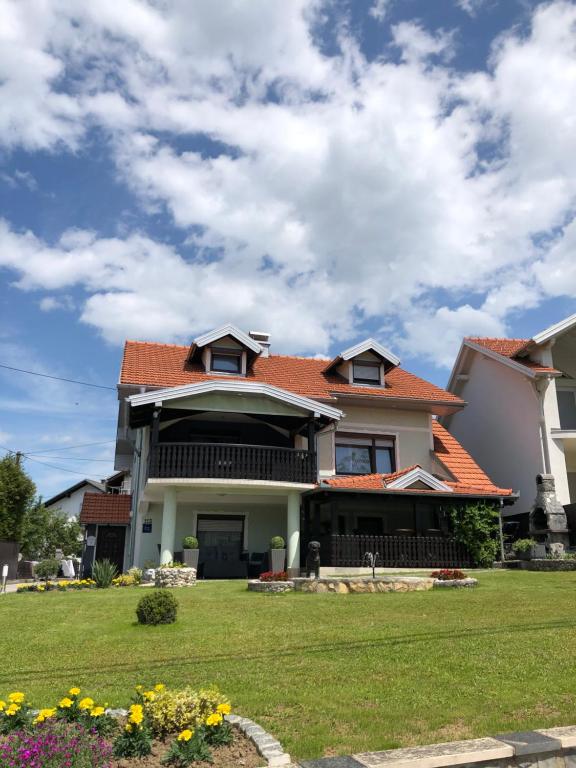 a large house with an orange roof at Sobe Darko Cindrić in Karlovac