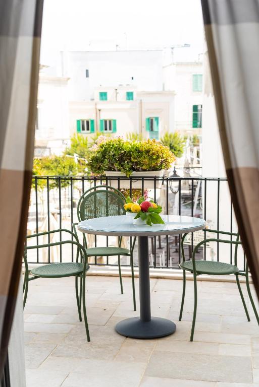 a table with a bowl of fruit on a balcony at Palazzo Indelli in Monopoli