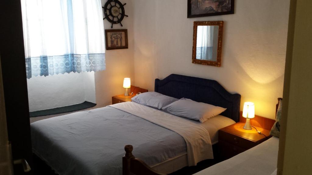 een slaapkamer met een bed, 2 lampen en een raam bij Apartment Radovic in Kotor
