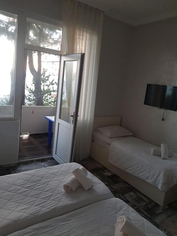 Postel nebo postele na pokoji v ubytování MIDIA Guest House