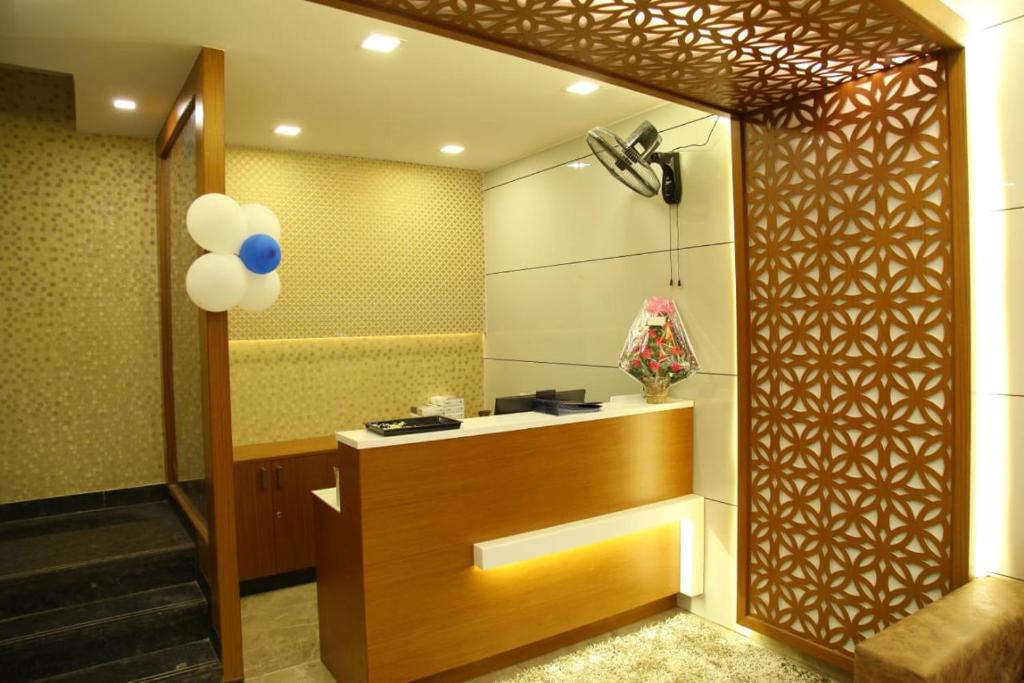 a room with a bathroom with a sink and a fan at century courtyard in Chennai