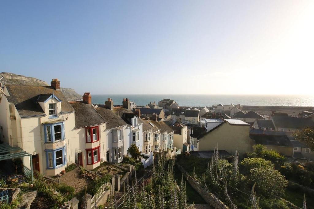 a view of a town with houses and the ocean at Sea View Cottage in Portland