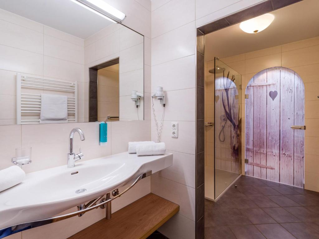 a bathroom with a sink and a shower at Appartements Schedererhaus in Going am Wilden Kaiser