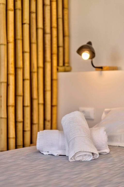 a stack of towels sitting on top of a bed at Guesthouse ERI in Kini