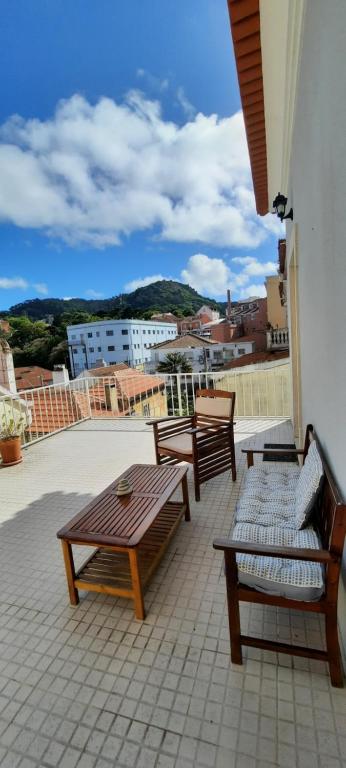 a patio with benches and tables on a building at CasAzulApartments in Sintra