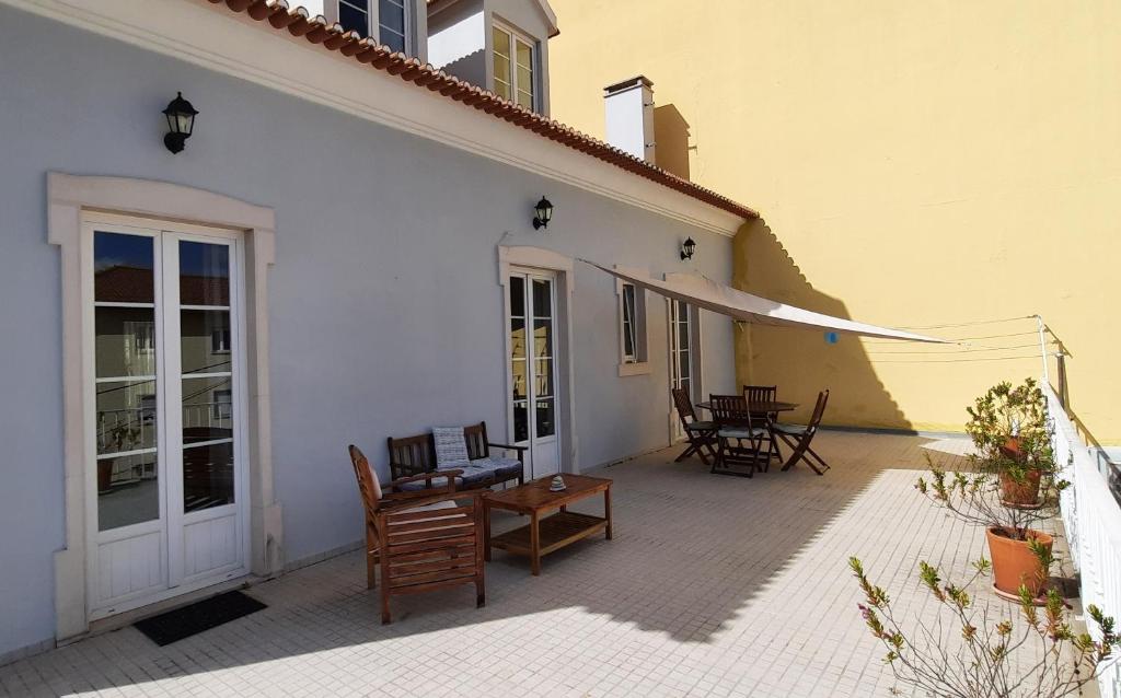 a patio with chairs and a table on a building at CasAzulApartments in Sintra