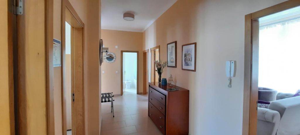 a hallway with a dresser and a living room at CasAzulApartments in Sintra