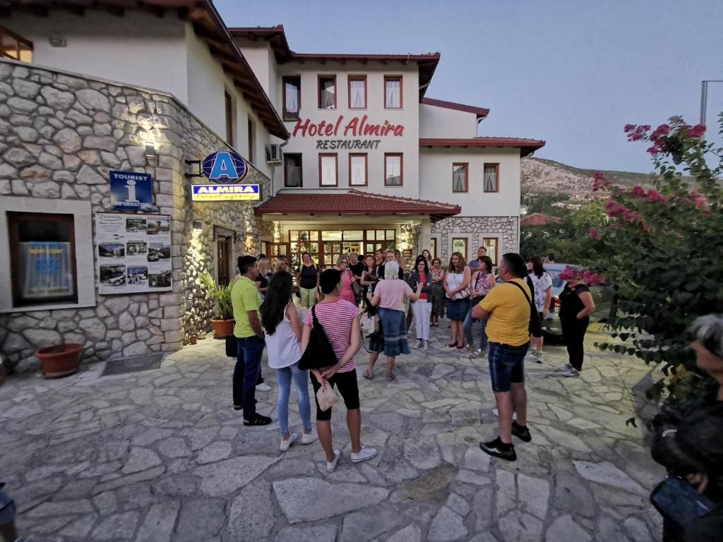 a group of people standing outside of a building at Hotel Almira in Mostar