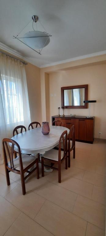 a dining room with a table and chairs in a room at CasAzulApartments in Sintra