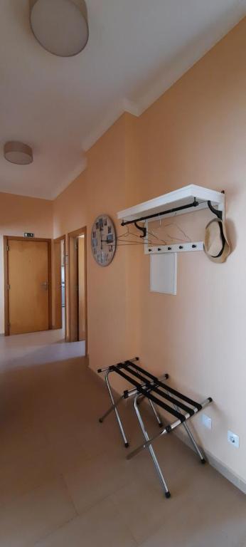 a empty room with a treadmill in a room with a clock at CasAzulApartments in Sintra