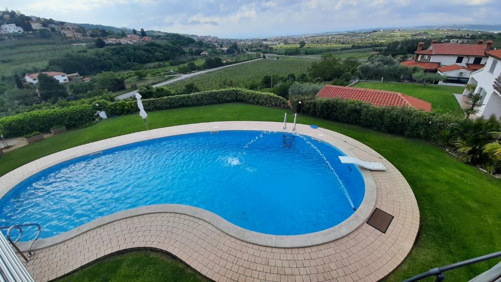 an overhead view of a large swimming pool in a yard at Relax Vila Kampel in Koper
