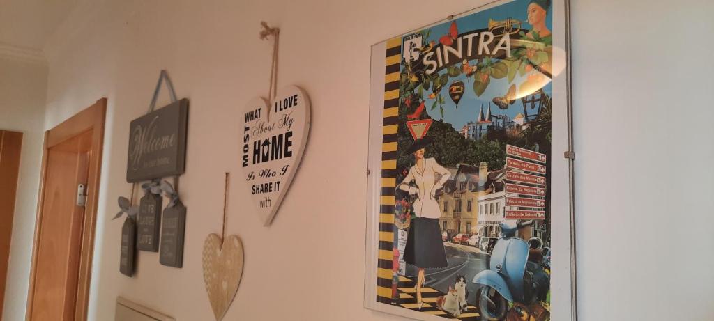 a poster on a wall with a picture on it at CasAzulApartments in Sintra