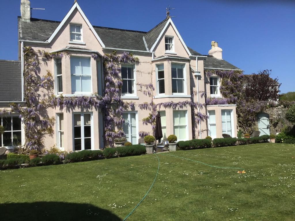 a large house with a lawn in front of it at Newton Cottage in Porthcawl