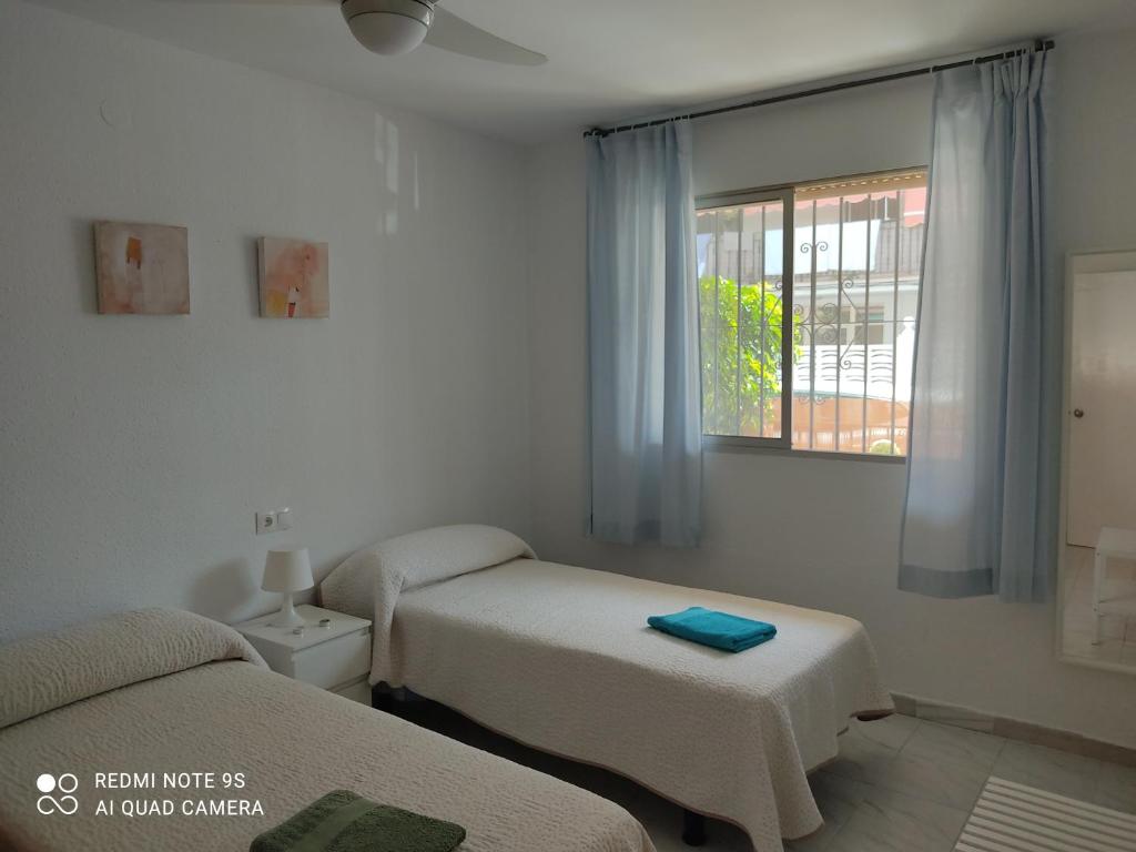 Postel nebo postele na pokoji v ubytování CASA SANTO a 2 minutos de la playa a pié y parking gratuito