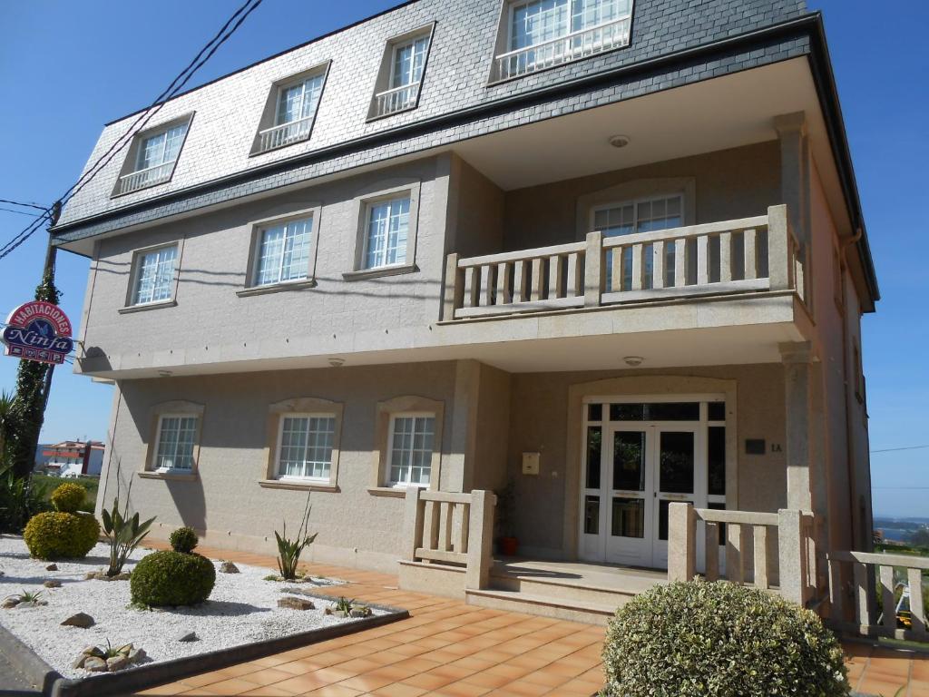 a large house with a porch and a balcony at Habitaciones Ninfa in Villalonga