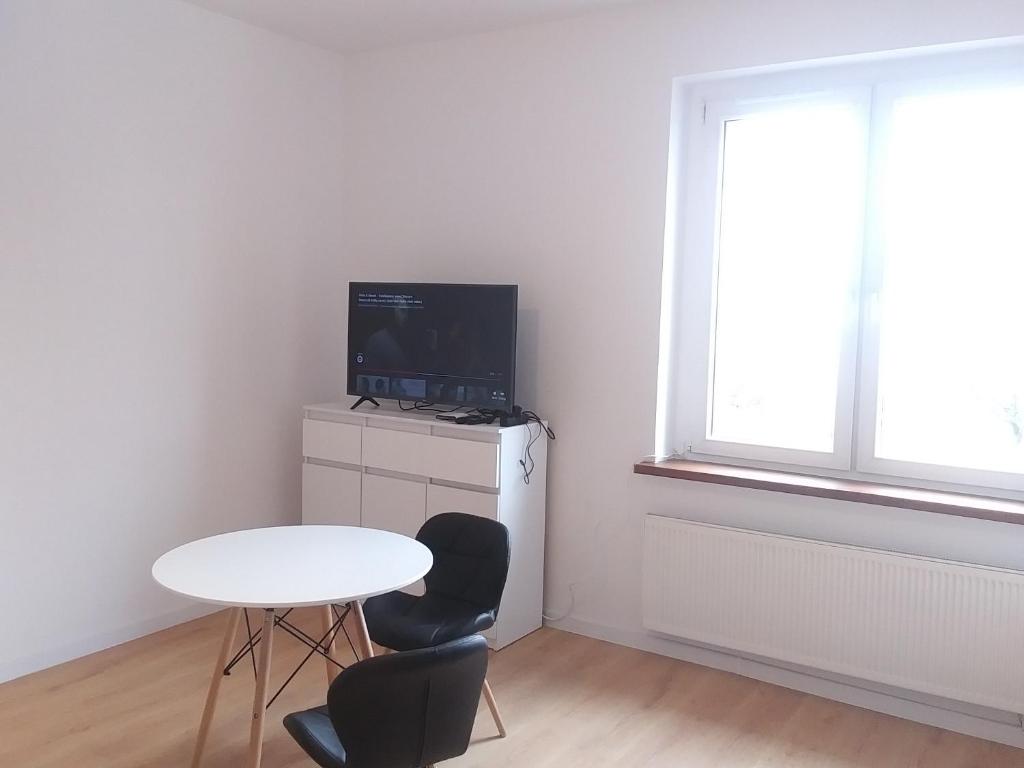 Televízia a/alebo spoločenská miestnosť v ubytovaní Marshal Foch Apartment