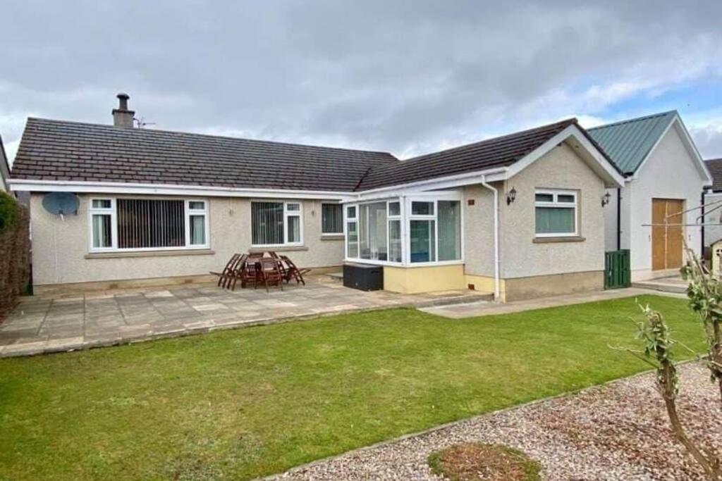 a detached house with a patio and grass at The Rothes Retreat in Aberlour