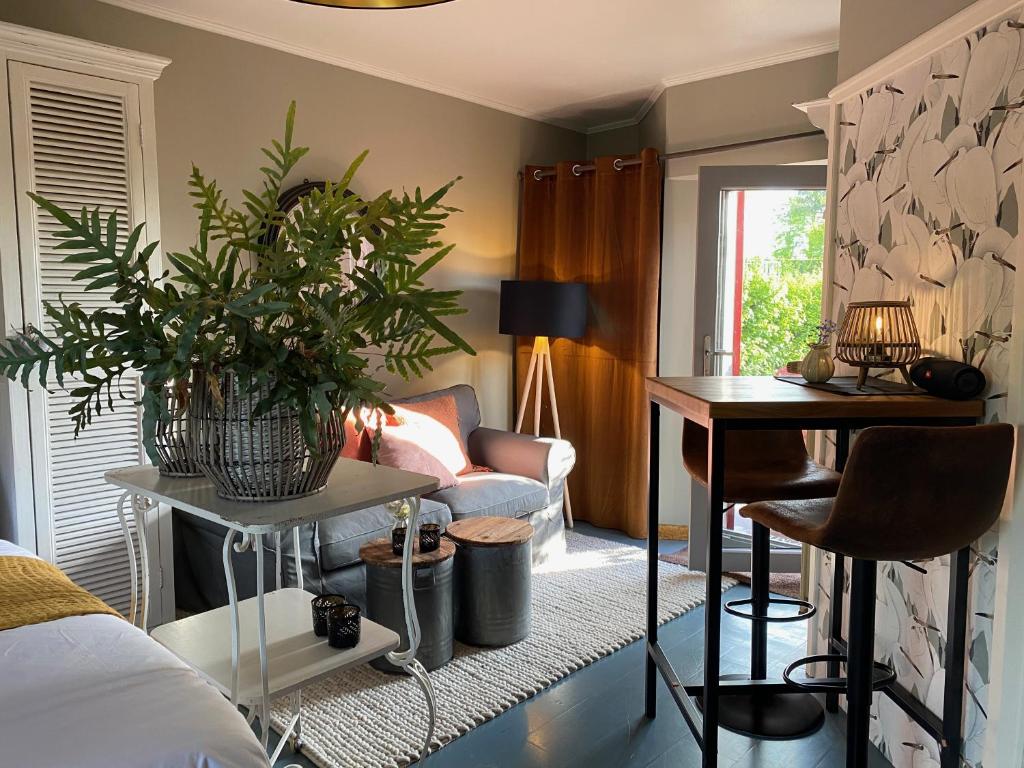 sala de estar con sofá y mesa con plantas en dashausderfloristin en Noertrange