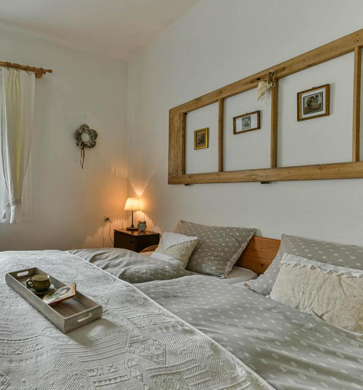 A bed or beds in a room at Halháza Erdészlak Apartman