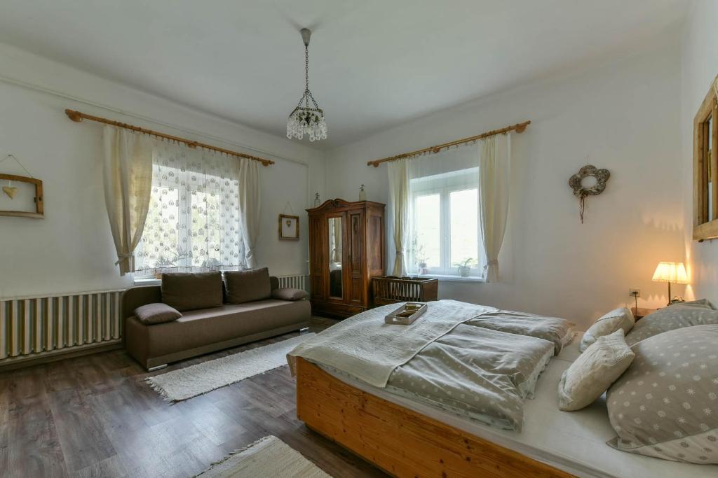 A bed or beds in a room at Halháza Erdészlak Apartman