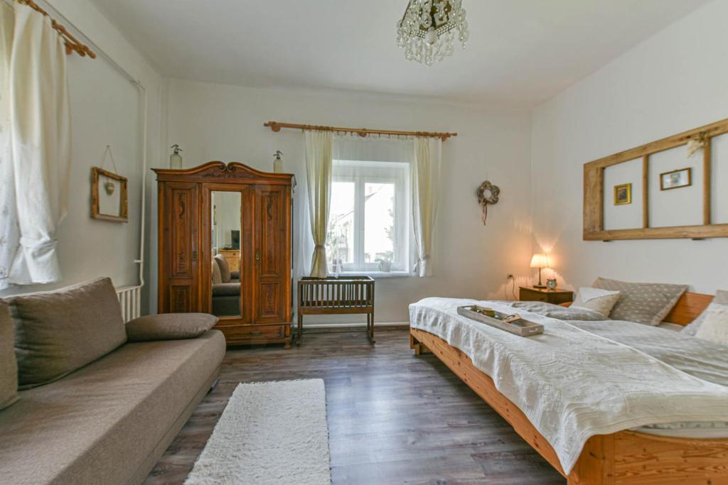 A bed or beds in a room at Halháza Erdészlak Apartman