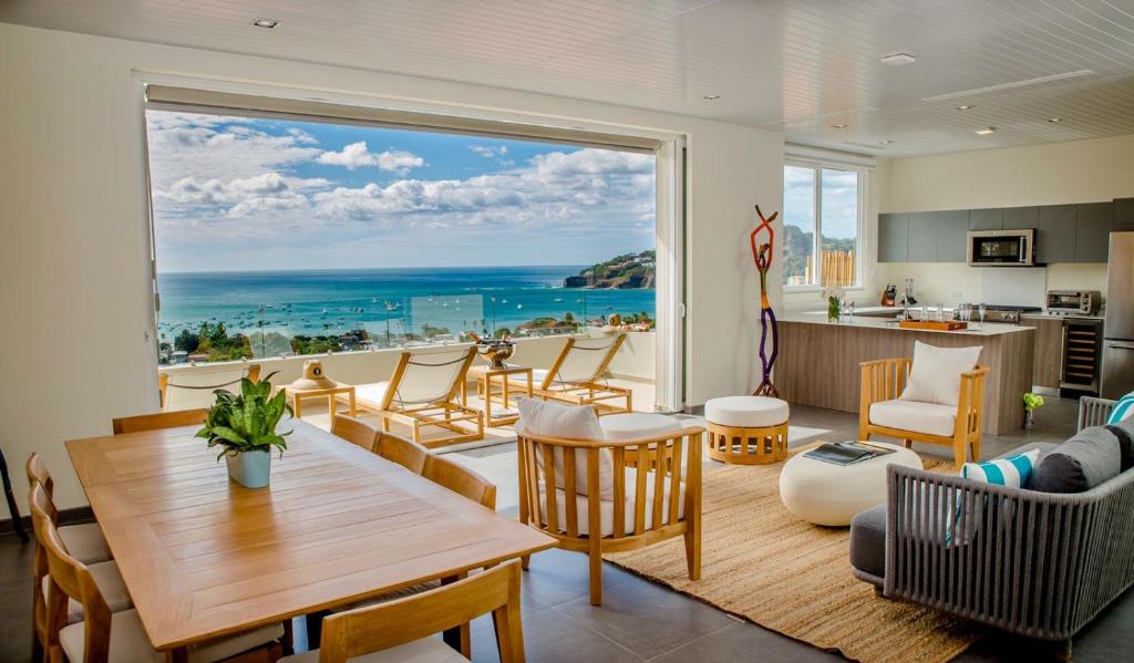 a living room with a view of the ocean at La Santa Maria Resort in San Juan del Sur