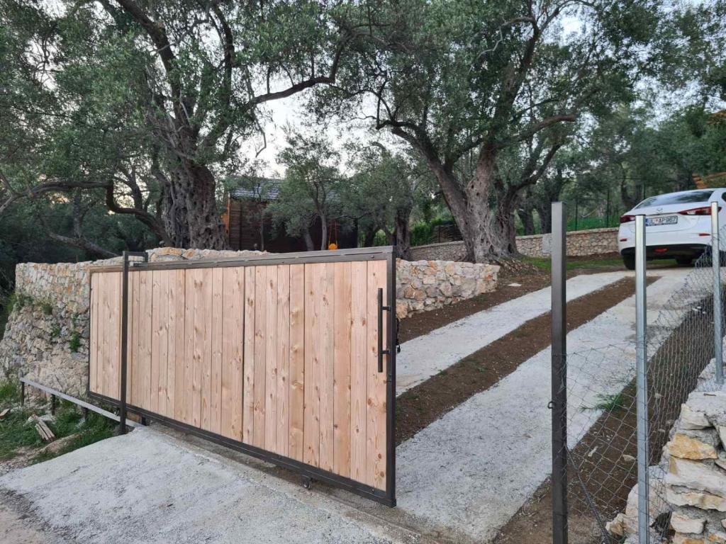 a wooden gate in front of a fence at OLEA COTTAGE in Ulcinj