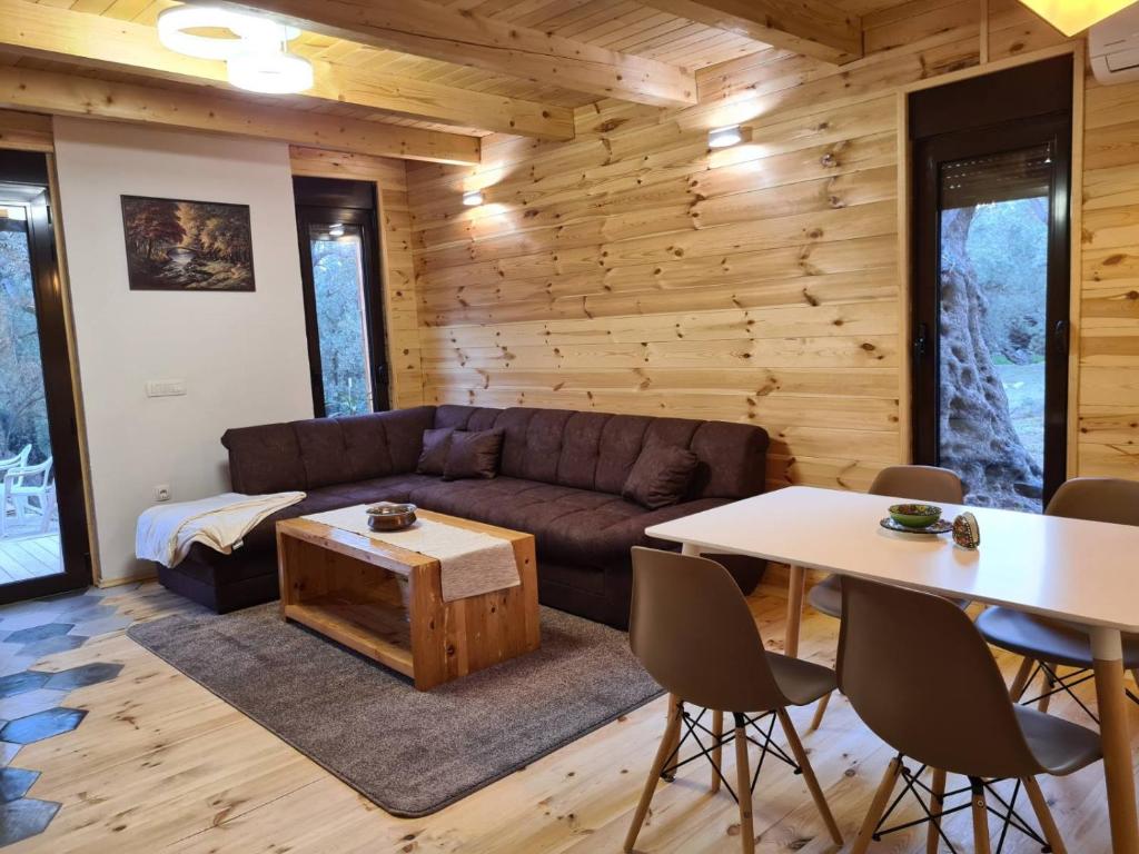 a living room with a couch and a table at OLEA COTTAGE in Ulcinj