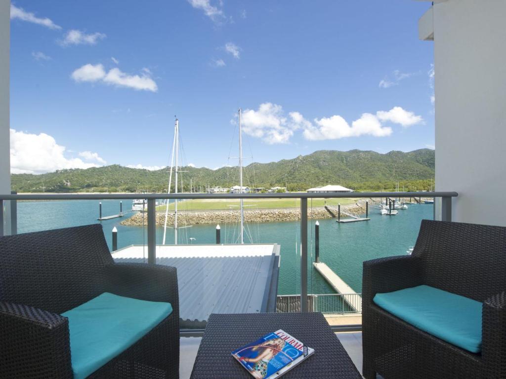 a balcony with a view of the water and boats at Blue on Blue Studio Room 1242 in Nelly Bay