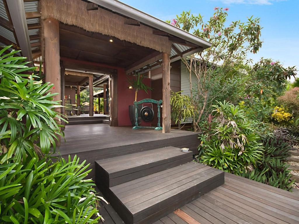 a house with a wooden deck in the yard at Banyak Villa in Horseshoe Bay