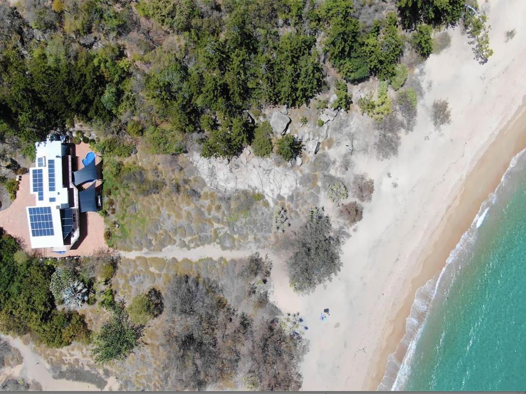 an aerial view of the beach and the ocean at The Beach House at Arthur Bay in Horseshoe Bay