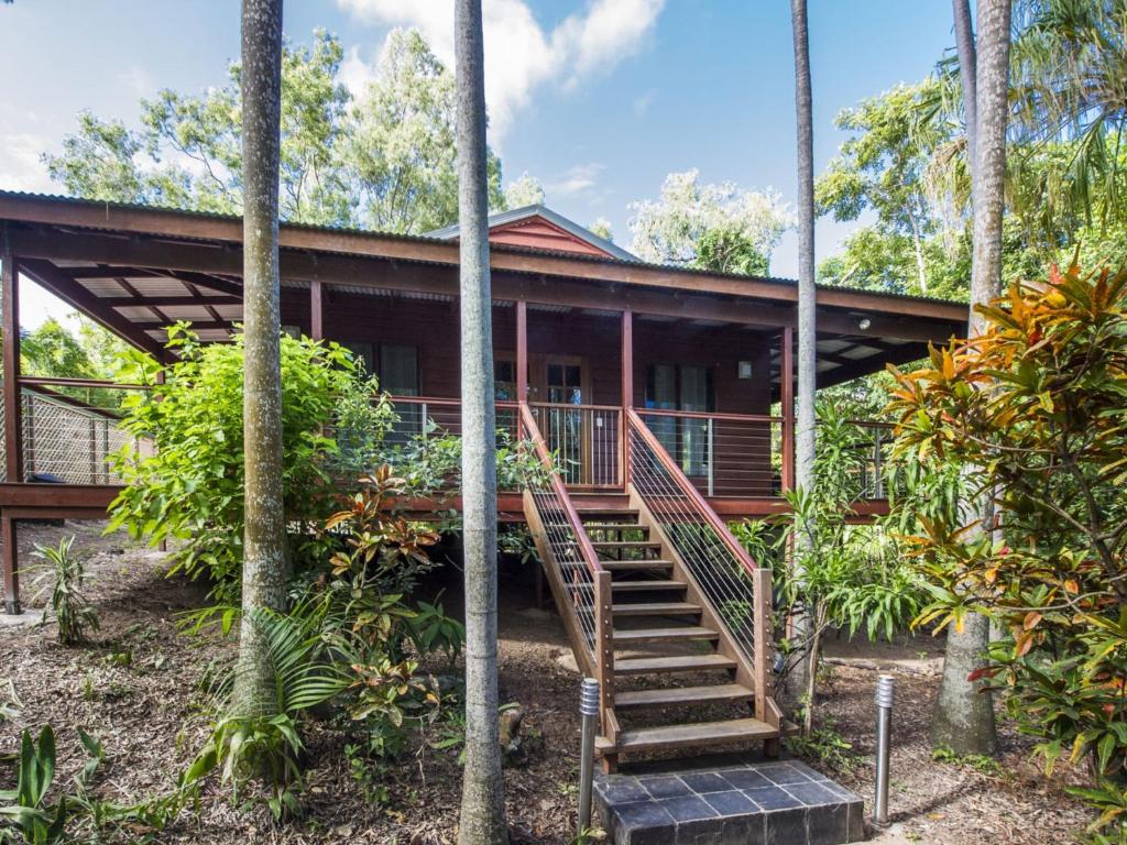 a house in the tropics with stairs leading to it at Magnetic Effect in Arcadia