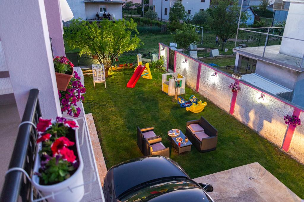 an aerial view of a backyard with a playground at Apartman Mona in Podgorica