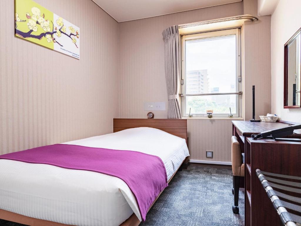 Postel nebo postele na pokoji v ubytování Central Hotel Okayama