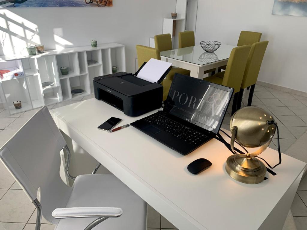 a laptop computer sitting on top of a table at PORTA HOME modern and hospitable in Naxos Chora