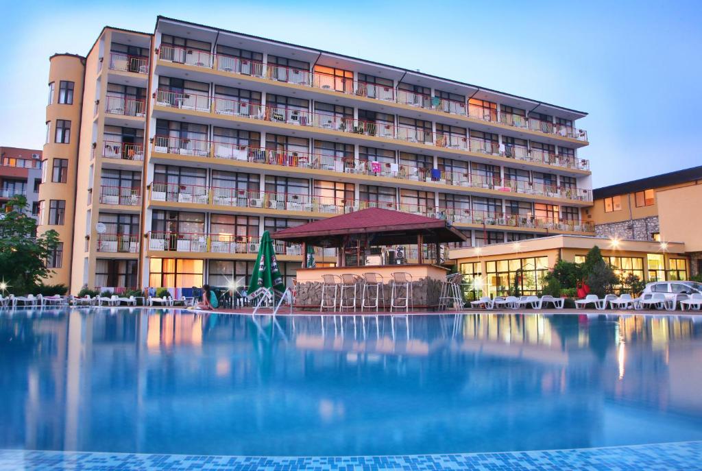 a large building with a large swimming pool in front of it at Hotel Trakia Garden in Sunny Beach