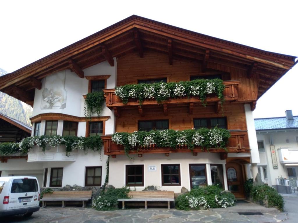 a building with benches in front of it at Ondres'n Hof in Längenfeld