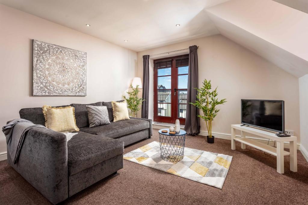a living room with a couch and a tv at Elliot Suite No9 - Donnini Apartments in Ayr