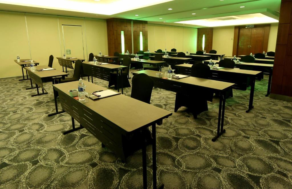 A large formal dining or event room set with rows of tables and chairs.