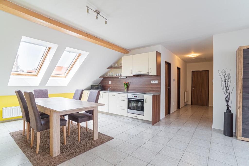 a kitchen and dining room with a table and chairs at Saeli Apartments in Mikulov