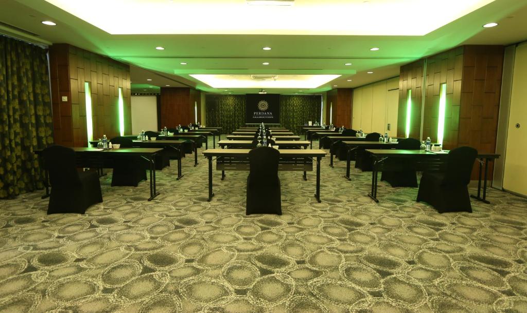 A large, formally set dining room with evenly spaced tables.
